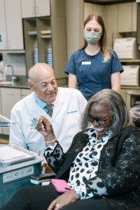 Brooklyn Orthodontist, Dr. Ronald Mizrahi laughing with a patient during their appointment